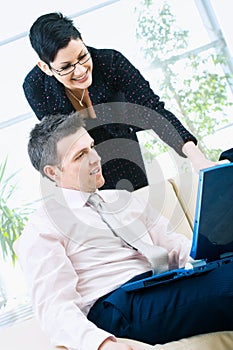 Happy businesspeople with computer