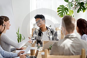 Happy businesspeople handshaking in office at meeting