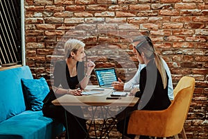 Happy businesspeople smiling cheerfully during a meeting in a coffee shop. Group of successful business professionals