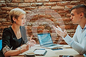 Happy businesspeople smiling cheerfully during a meeting in a coffee shop. Group of successful business professionals