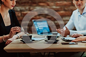 Happy businesspeople smiling cheerfully during a meeting in a coffee shop. Group of successful business professionals