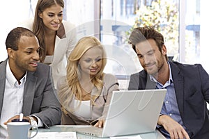 Happy businessteam working with laptop computer