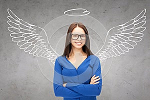 Happy businesswoman with angel wings and nimbus photo