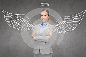 Happy businesswoman with angel wings and nimbus