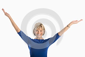 Happy Businesswoman With Arms Raised Against White Background