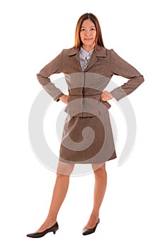 Happy businesswoman in brown suit is smiling and arms akimbo on