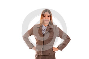 Happy businesswoman in brown suit is smiling and arms akimbo on