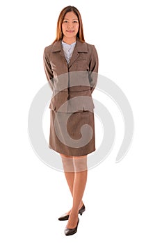 Happy businesswoman in brown suit is standing and smiling on white background.