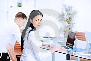 Happy businesswoman with colleagues in the background