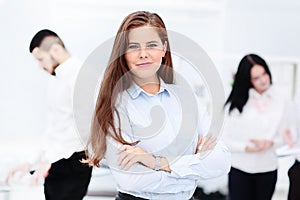 Happy businesswoman with colleagues in the background