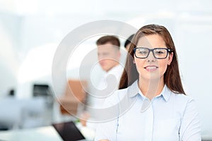 Happy businesswoman with colleagues in the background