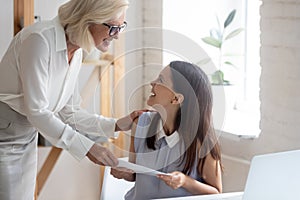 Happy businesswoman congratulate smiling female employee with promotion