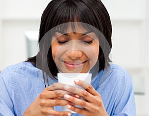 Happy businesswoman drinking a coffee