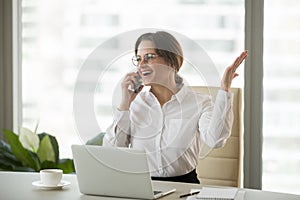Happy businesswoman excited about hearing good news talking on p