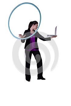 A happy businesswoman exercising with a hula- hoop