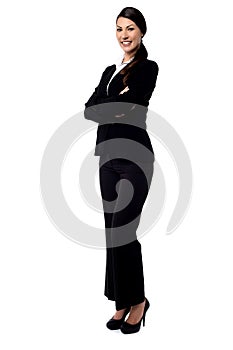 Happy businesswoman with folded arms.