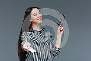 Happy businesswoman giving blank card at camera