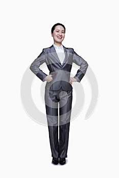 Happy businesswoman with hands on her hips