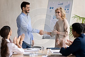 Happy businesswoman handshake greeting employee with promotion