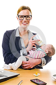 Happy businesswoman holding baby