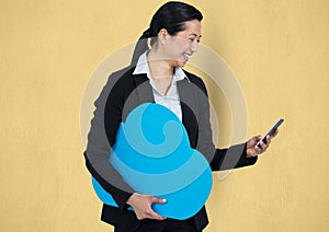 Happy businesswoman holding cloud while using smart phone