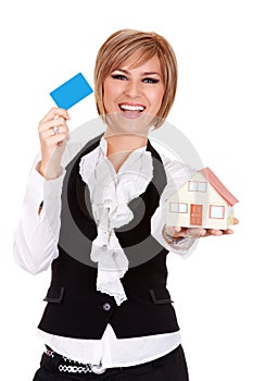 Happy businesswoman holding credit card and toy house