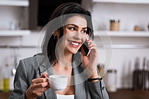 Happy businesswoman holding cup of coffee