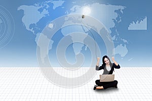 Happy businesswoman with laptop and light bulb on blue world map