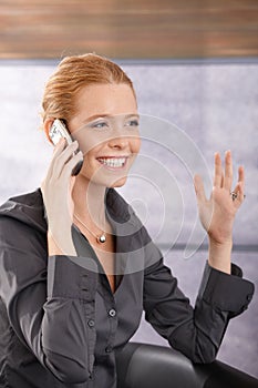 Happy businesswoman laughing on phone call