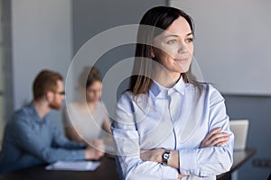 Smiling businesswoman looking from window dreaming of future suc photo