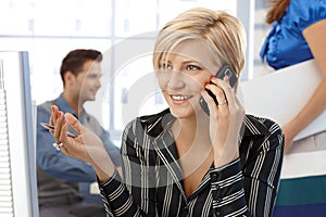 Happy businesswoman on phone call