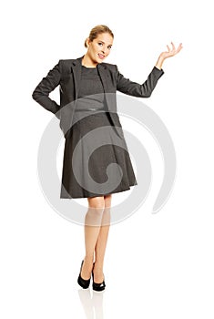 Happy businesswoman presenting copy space