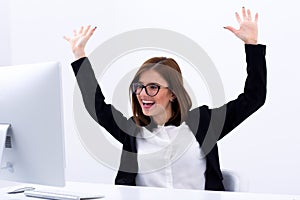 Happy businesswoman with raised hands up