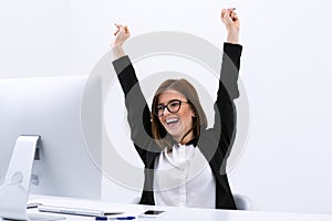 Happy businesswoman with raised hands up