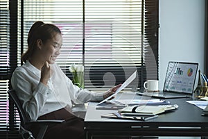 Happy businesswoman reading good news on computer laptop and celebrating her success. Successful work concept