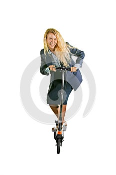 Happy businesswoman rides a kick scooter on studio