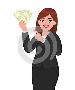Happy businesswoman showing or holding cash, money, dollar, currency notes in hand and pointing, gesturing hand. Modern lifestyle.