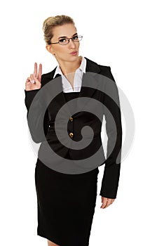Happy businesswoman showing victory sign