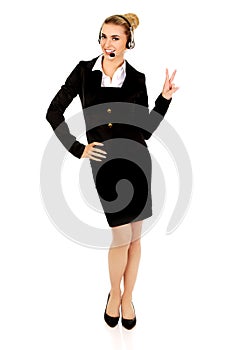 Happy businesswoman showing victory sign.