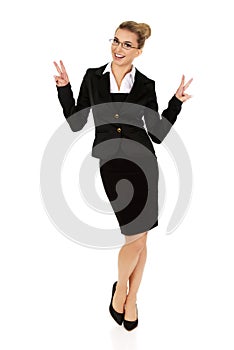 Happy businesswoman showing victory sign