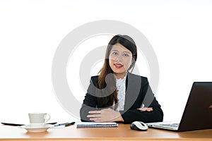 Happy Businesswoman Sitting At Office Desk