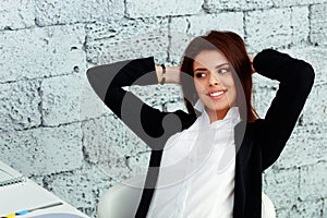 Happy businesswoman sitting at the table