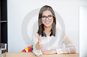 Happy businesswoman sitting at the table