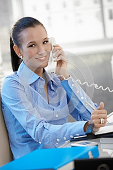 Happy businesswoman speaking on phone