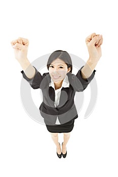 Happy businesswoman with success gesture