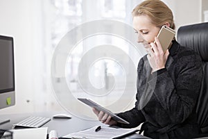 Happy Businesswoman with Tablet Talking on Phone