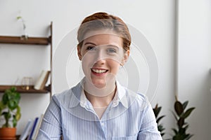 Happy businesswoman talking by video conference call looking at webcam