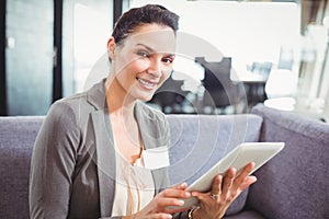 Happy businesswoman using digital tablet