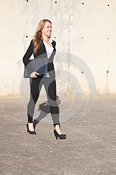 Happy businesswoman walking on the street