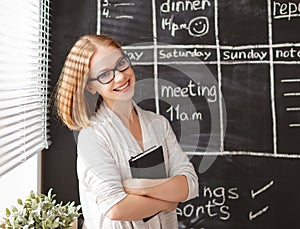 Happy businesswoman woman at school board with schedule planning